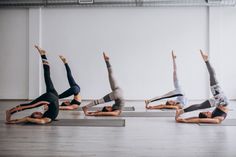 a group of people doing yoga poses in a row on their stomachs and arms