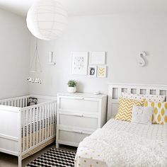 a baby's room with a crib, dresser and bed in white and yellow colors