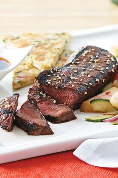 a white plate topped with meat and veggies