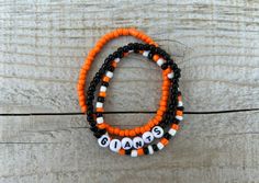 These Giants bracelets are the perfect way to show your team pride for the big game! Pair them with any outfit. This listing is for 3 bracelets as shown in pictures.  TO ORDER:  1. Pick bracelet length  2. Pick letter color 3. Submit and I'll get to work :)  PRODUCT DETAILS:  - Bracelets are made with sturdy jewelry elastic - Listing is for three bracelets  - All orders are final. Please double check your bracelet size  CARING TIPS:  - Do not expose jewelry to water  - Treat and store jewelry gently  - Roll bracelets on rather than stretching band to get on  Don't see your teams bracelets on our shop? Or have a custom team bracelet you want? Head to this link to order your custom ones!  https://kanaeohana.etsy.com/listing/1591607617/custom-sports-team-bracelets-team  We are HAPPY to do bul Adjustable Beaded Bracelets For Game Day With School Spirit, Team Spirit Bracelets With Letter Beads, Game Day Bracelets With Letter And Round Beads, Team Spirit Beaded Bracelets For Game Day, Game Day Team Spirit Stretch Bracelet With Round Beads, Team Spirit Round Beads Jewelry For Game Day, It Band Stretches, Team Bracelets, Baseball Bracelet