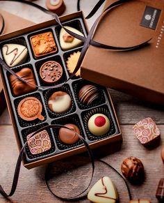 an assortment of chocolates in a box on a table