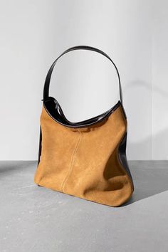 Chic Leather Accessory: Elevate Every Ensemble Step into a world of refined minimalism with our designer hobo shoulder bag. Showcasing a unique saddle shape and precision-crafted from color-blocked suede leather, this piece marries opulence with a relaxed European flair. Available in shades of caramel brown and rich cocoa, accentuated by contemporary contrast detailing, it stands as an ode to impeccable craftsmanship. Inside, you'll find a thoughtfully partitioned design, bolstered by a robust p Chic Cognac Hobo Bag For Office, Elegant Camel Shoulder Bag With Large Capacity, Minimalist Brown Soft Leather Hobo Bag, Elegant Large Capacity Camel Shoulder Bag, Chic Rectangular Hobo Bag With Leather Backing, Minimalist Brown Leather Hobo Bag, Chic Cognac Textured Leather Hobo Bag, Chic Hobo Bag With Leather Backing, Camel Leather Shoulder Bag For Work