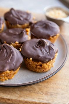 chocolate frosted cupcakes sitting on top of a plate