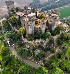 an aerial view of a castle surrounded by trees