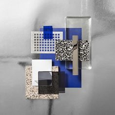 an abstract painting with blue, white and black squares on it's surface is shown