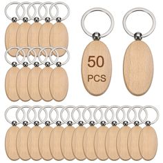 wooden keychains with metal rings and wood tags on them are shown in different sizes