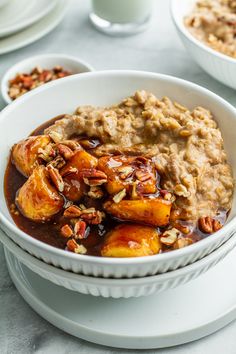 a bowl filled with oatmeal and bananas on top of a white table