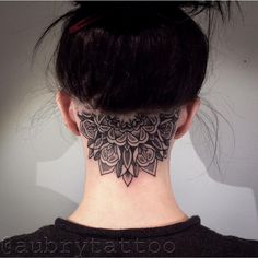 a woman with a neck tattoo that has flowers on it