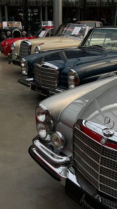 several old cars are lined up in a row