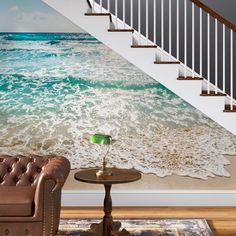 an ocean scene with waves crashing on the beach and stairs leading up to the second floor