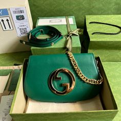 Coming from the House's archives, a round shaped version of the Interlocking G logo is reintroduced for Gucci Love Parade. Crafted from emerald green leather, this shoulder bag is completed by a delicate chain strap, infusing this accessory with a refined feel. Gold-toned hardware Round Interlocking G Leather shoulder strap with 15.4" drop Magnetic closure Small: 11"W x 6.3"H x 1.6"D Made in Italy Gucci Blondie Bag, Gucci Green Bag, Bags Wishlist, Green Gucci, Tas Bahu, Gucci Brand, Green Leather, Brunei, Chain Strap