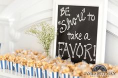 popcorn is sitting on the shelf next to a sign