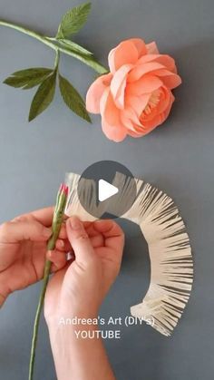 someone is making a flower out of paper