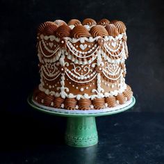 a chocolate cake with white frosting and decorative decorations