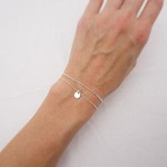 MADE WITH SOLID STERLING SILVER PARTS - A GREAT KEEPSAKEThis bracelet set features two beautiful pieces. The tiny sterling silver disc on one bracelet adds a dainty touch to a simple piece. The lightweight charm slides freely along the chain. The second bracelet features a simple sterling silver chain to complement the minimalist design. Comes in a gift box, perfect for gift giving. SIZING - IMPORTANT: To determine bracelet size, measure snugly around your wrist and add 1/2 inch to get your brac Mothers Birthstone Bracelet, Disc Bracelet, Bracelet Set Silver, Tiny Charm, Moms Bracelet, Bracelet Dainty, Bridesmaid Bracelet, Layered Bracelets, Sterling Silver Bracelet