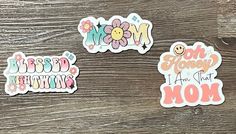 three stickers with the words mom and flowers on them