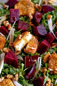 a salad with beets, carrots and goat cheese on top is featured in this post