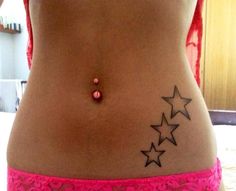 a woman's stomach with three stars tattooed on the lower part of her belly