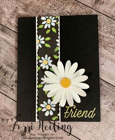 a handmade card with white flowers and the word friend written on it's side