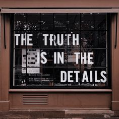 a store front window with the words, the truth is in the details