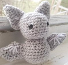 a crocheted stuffed animal sitting on top of a window sill next to a window