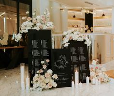 the table is set up with flowers and menus on it, along with candles