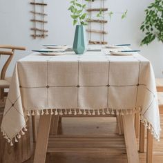 a table with a vase and plates on it