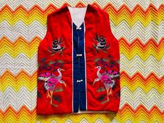 **Please see ALL photos for reference and review FULL description as returns are generally NOT accepted.** This FABULOUS vest is vintage and from China. It has amazing animals embroidered on it and it just can't be passed up! Size fits like a Small-Medium. Easy to care for and can be machine washed. It has the most adorable buttons and blue stripe down the front. This is perfect for the Fall season or for transitioning into Winter/Spring!  Has been washed and has no smells or odors. Overall, in very good vintage condition there are some spotting and piling issues on the inside of the vest. As well as some minor loose threads near the seam of the shoulders. However, the vest is intact. Measurements laying flat are: Pit to pit: 18" Inside neck width is: 5.5"  Waist: 18.5"  Sleeve opening: 7" Red Bohemian Sleeveless Vest, Retro Red Winter Vest, Red Embroidered Sleeveless Vest, Red Retro Cotton Vest, Fitted Multicolor Vintage Vest, Fall Vest, Boho Vest, Sweater Vest Women, Animal Embroidery