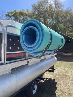 a large pipe is attached to the back of a truck with an american flag painted on it