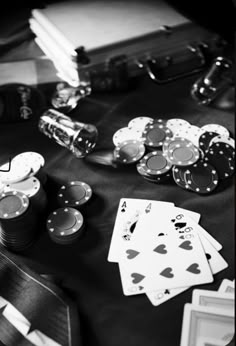 black and white photograph of playing cards, poker chips, lighters and other items