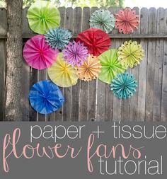 some paper flowers hanging from a fence with the words paper tissue flower bouquet on it