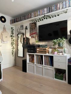 a living room filled with furniture and a flat screen tv on top of a wall