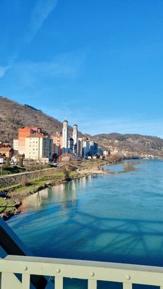 a river running through a city surrounded by mountains