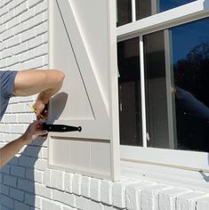 a man is using a window sealer to clean the windows