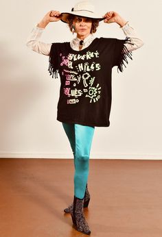 "Beverly Hills Blues/ Vintage Black T-Shirt/ Black Fringe T-Shirt/ Fringe T-Shirt/ Beverly Hills T-Shirt/ Neon T-Shirt/ Size M Super fun vintage t-shirt in excellent pre-worn condition. Neon letter graphic in neon. Fringe sleeves! Model is 5'4\" and a size 4 for scale. Please see exact measurements below. Item measured while flat, double where applicable, i.e. waist, hips. Shoulder to shoulder Armpit to armpit Waist Sleeve length T-shirt length 100% cotton." Alternative Black Stretch T-shirt, Stretch Graphic Print Top For Alternative Fashion, Stretch Tops With Graphic Print For Alternative Fashion, Oversized Crew Neck T-shirt For Alternative Fashion, Edgy Blue Graphic Print Tops, Edgy Blue Tops With Graphic Print, Black T-shirt With Text Print For Alternative Fashion, Punk Style Crew Neck Stretch T-shirt, Punk Style Stretch T-shirt With Crew Neck