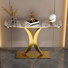 a marble and gold console table with vases on it in front of a wall