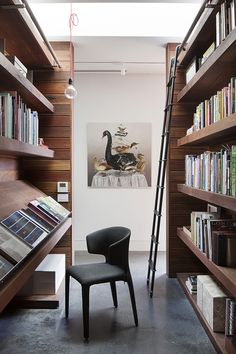 a chair in front of a bookshelf full of books