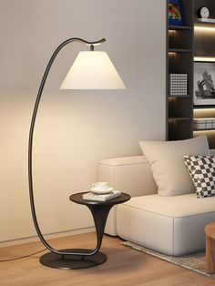 a living room with a couch, lamp and coffee table in front of the bookshelf