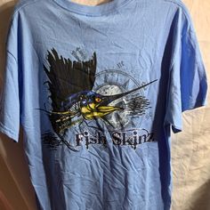 New T-Shirt. Nice Light Blue Color. Fishing Reel Nautical Boating Theme. H Fish Shirt, Boat Theme, Brown Tshirt, Tech Shirt, Lacoste Men, Blue Logo, North Face Mens, Fishing Shirts, Light Blue Color