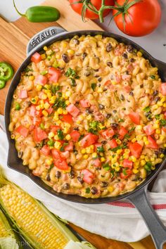 southwest macaroni and cheese in a skillet with corn on the cob