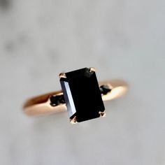 a black diamond ring sitting on top of a table