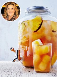 a mason jar filled with water and lemon slices next to a glass of iced tea