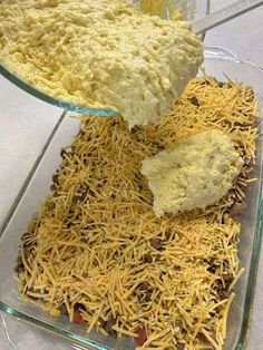 a person scooping cheese from a casserole dish