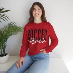 This Soccer Coach Crewneck Sweatshirt offers a cozy and stylish way for soccer coaches to show off their support during games and practices. The relaxed fit and lightweight fabric make it perfect for layering or wearing on its own. Ideal for soccer coaches looking for a comfortable and fashionable way to cheer on their team. Care instructions - Machine wash: cold (max 30C or 90F) - Do not bleach - Tumble dry: low heat - Iron, steam or dry: low heat - Do not dryclean Ideal for any situation, a un Team-colored Sports Sweatshirt, Team-colored Sweatshirt For Sports, Team-colored Sweatshirt With Team Name For Sports, Collegiate Moisture-wicking Sweatshirt For Sports, Sporty Relaxed Fit Sweatshirt For Sports Events, Team-colored Sweatshirt For Sports Season, Team Spirit Sweatshirt With Team Name For Sports, Team Spirit Moisture-wicking Sweatshirt For Sports Events, Sporty Sweatshirt For Football Season Sports Events