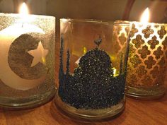 three lit candles sitting on top of a wooden table