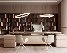 an office with two chairs and a desk in front of a book shelf filled with books