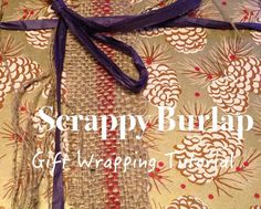 a wrapper wrapped in purple ribbon on top of a piece of fabric with the words scrappy burlap