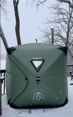 an inflatable tent sitting on top of snow covered ground