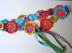 two crocheted flowers are attached to a lanyard