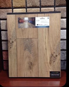 a wooden frame sitting on top of a table next to carpet swatches and rugs